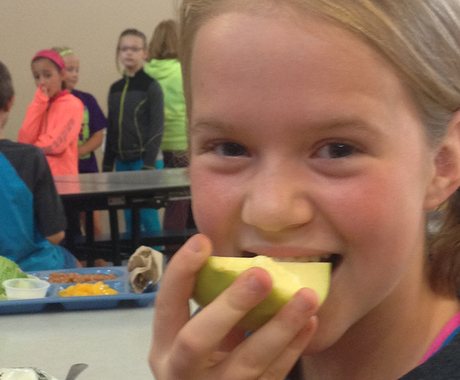 Girl biting into apple