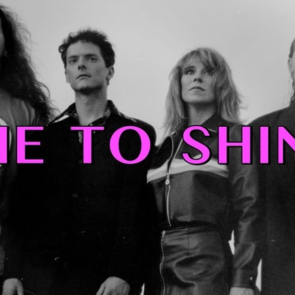 A black and white photograph with three men and a blonde woman and the words 'Time to Shine' in pink across the center of the image
