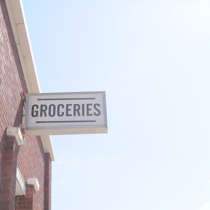 Groceries sign on the side of a building