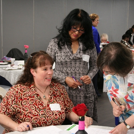 Three women networking at a table