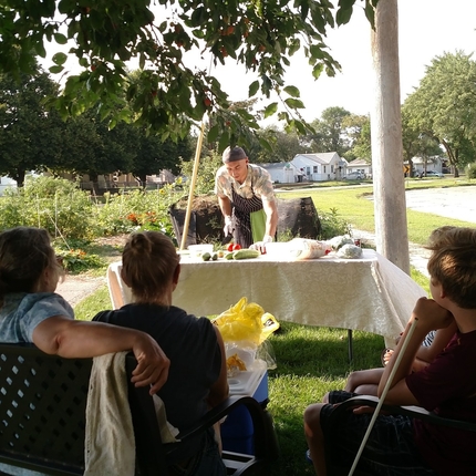 Center staff giving a cooking demonstration outside