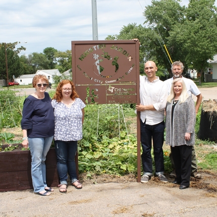 Center staff and others standing near community garden