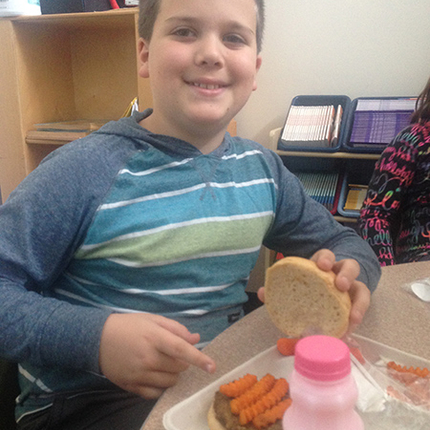 Boy eating school lunch