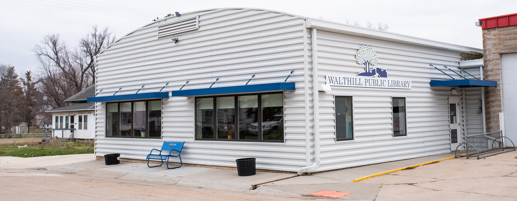 Walthill Public Library - White building with blue awnings
